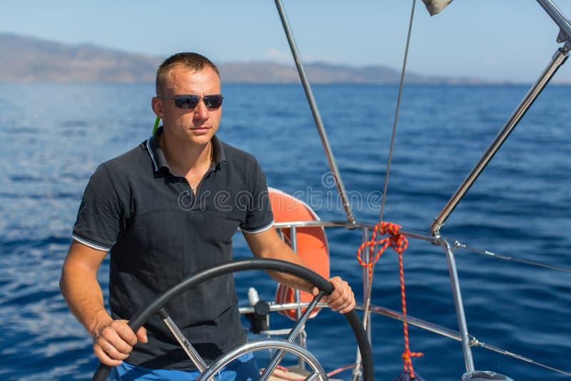 man-skipper-steers-sailing-boat-sea-luxury-yacht-80327446